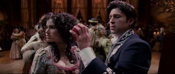 Movie still from “Enchanted” (2007), directed by Kevin Lima – A man and a woman in a costume in front of a crowd; Close Up shot, Over the shoulder angle
