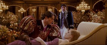 Movie still from “Enchanted” (2007), directed by Kevin Lima – Two men and a woman in a room; Medium shot, Over the shoulder angle