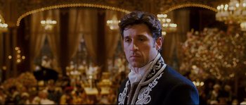 Movie still from “Enchanted” (2007), directed by Kevin Lima – A person wearing a suit and tie; Medium shot, Over the shoulder angle