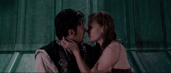 Movie still from “Enchanted” (2007), directed by Kevin Lima – A man and a woman kissing in the rain; Medium shot, Overhead angle