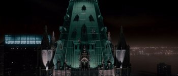 Movie still from “Enchanted” (2007), directed by Kevin Lima – A large green building with many windows and spires; Extreme Wide shot, Low angle