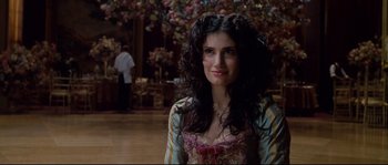 Movie still from “Enchanted” (2007), directed by Kevin Lima – A woman with long black curly hair in a room; Close Up shot, Over the shoulder angle