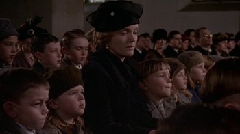 Movie still from “Enchanted April” (1991), directed by Mike Newell – A group of people sitting in a room; Close Up shot, Low angle