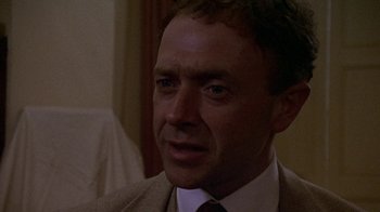 Movie still from “Enchanted April” (1991), directed by Mike Newell – A person wearing a suit and tie; Close Up shot, Low angle