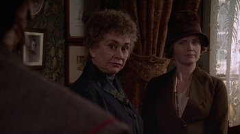 Movie still from “Enchanted April” (1991), directed by Mike Newell – An older woman standing in front of another woman; Close Up shot, Over the shoulder angle