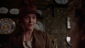 Movie still from “Enchanted April” (1991), directed by Mike Newell – A woman wearing a brown hat and a brown jacket; Close Up shot, Over the shoulder angle