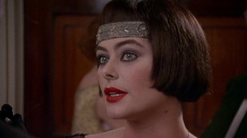 Movie still from “Enchanted April” (1991), directed by Mike Newell – A person wearing a head band; Close Up shot, Over the shoulder angle