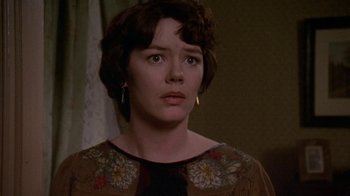 Movie still from “Enchanted April” (1991), directed by Mike Newell – A person with short brown hair; Close Up shot, Over the shoulder angle