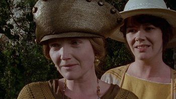 Movie still from “Enchanted April” (1991), directed by Mike Newell – A woman wearing a straw hat and a woman wearing a straw hat; Close Up shot, Over the shoulder angle