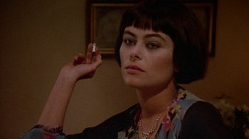 Movie still from “Enchanted April” (1991), directed by Mike Newell – A woman holding a cigarette in her right hand; Close Up shot, Over the shoulder angle