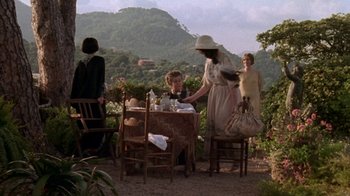 Movie still from “Enchanted April” (1991), directed by Mike Newell – A group of people sitting at a table outside; Wide shot, High angle