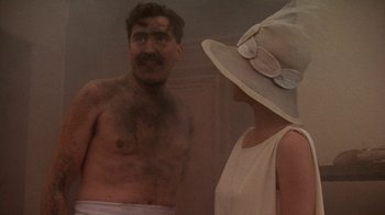 Movie still from “Enchanted April” (1991), directed by Mike Newell – A man and a woman in a steam room; Medium shot, Over the shoulder angle