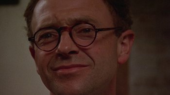 Movie still from “Enchanted April” (1991), directed by Mike Newell – A person wearing glasses; Close Up shot, Low angle