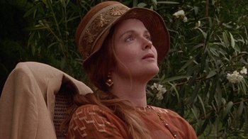 Movie still from “Enchanted April” (1991), directed by Mike Newell – A woman with long red hair wearing a hat; Close Up shot, Low angle
