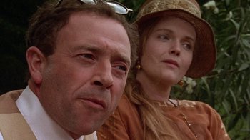 Movie still from “Enchanted April” (1991), directed by Mike Newell – A man and a woman standing next to each other; Close Up shot, Low angle