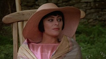 Movie still from “Enchanted April” (1991), directed by Mike Newell – A person wearing a hat; Close Up shot, High angle
