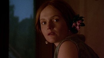 Movie still from “Enchanted April” (1991), directed by Mike Newell – A person with a flower in her hair; Close Up shot, Low angle