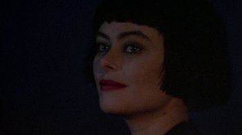 Movie still from “Enchanted April” (1991), directed by Mike Newell – A person wearing a black shirt; Close Up shot, Over the shoulder angle