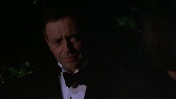 Movie still from “Enchanted April” (1991), directed by Mike Newell – A man wearing a tuxedo and a bow tie; Close Up shot, Low angle