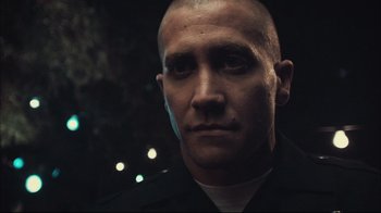 Movie still from “End of Watch” (2012), directed by David Ayer – A person wearing a police uniform; Close Up shot, Low angle