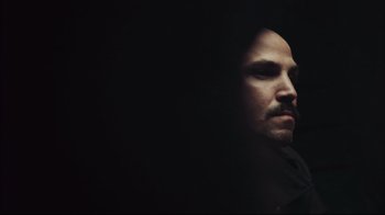 Movie still from “End of Watch” (2012), directed by David Ayer – A person in a dark room; Close Up shot, High angle