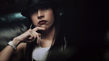 Movie still from “End of Watch” (2012), directed by David Ayer – A woman wearing a black hat and a white shirt; Extreme Close Up shot, High angle