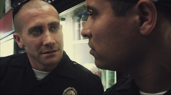 Movie still from “End of Watch” (2012), directed by David Ayer – Two police officers talking to each other in a room; Close Up shot, Over the shoulder angle