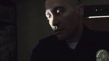 Movie still from “End of Watch” (2012), directed by David Ayer – A man with bald head looking into the distance; Close Up shot, Low angle