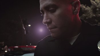 Movie still from “End of Watch” (2012), directed by David Ayer – A person wearing a suit; Close Up shot, Low angle