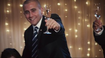 A man in a suit holding a glass of champagne