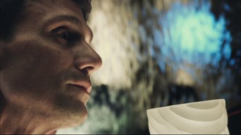 Movie still from “End of Watch” (2012), directed by David Ayer – A man's face with a plate in front of him; Close Up shot, Low angle