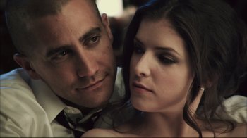 Movie still from “End of Watch” (2012), directed by David Ayer – A man and a woman posing for a picture; Close Up shot, Low angle