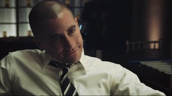 Movie still from “End of Watch” (2012), directed by David Ayer – A man in a white dress shirt and black tie smiling; Close Up shot, Over the shoulder angle