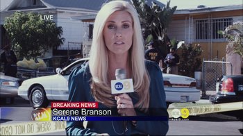 Movie still from “End of Watch” (2012), directed by David Ayer – A woman is sitting in front of a microphone; Medium shot, Over the shoulder angle