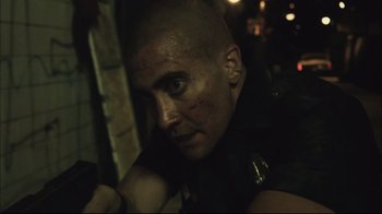 Movie still from “End of Watch” (2012), directed by David Ayer – A man with a shaved head is looking at the camera; Close Up shot, Low angle