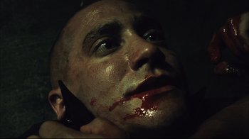 Movie still from “End of Watch” (2012), directed by David Ayer – A person with blood on his face; Close Up shot, Low angle