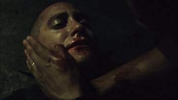 Movie still from “End of Watch” (2012), directed by David Ayer – A person's face in a dark room; Close Up shot, Over the shoulder angle