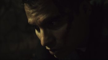 Movie still from “End of Watch” (2012), directed by David Ayer – A man's face in the dark; Extreme Close Up shot, Low angle