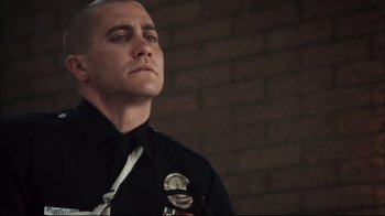 Movie still from “End of Watch” (2012), directed by David Ayer – A police officer is looking up into the sky; Close Up shot, Low angle