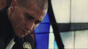 Movie still from “End of Watch” (2012), directed by David Ayer – A police officer is looking down at his watch; Close Up shot, Low angle