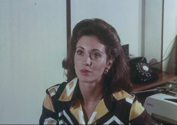 Movie still from “Enforcer from Death Row” (1976), directed by Efren C. Piñon – A person wearing a dress; Medium shot, Low angle