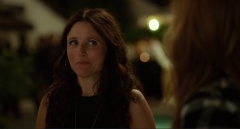 Movie still from “Enough Said” (2013), directed by Nicole Holofcener – A person with long hair; Close Up shot, Over the shoulder angle