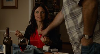 Movie still from “Enough Said” (2013), directed by Nicole Holofcener – A woman sitting at a dinner table with a man; Medium shot, Over the shoulder angle