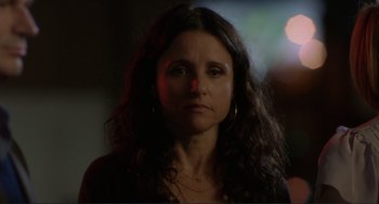 Movie still from “Enough Said” (2013), directed by Nicole Holofcener – A person with long curly hair; Close Up shot, Low angle