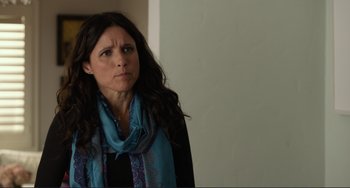 Movie still from “Enough Said” (2013), directed by Nicole Holofcener – A person wearing a blue scarf; Close Up shot, Over the shoulder angle