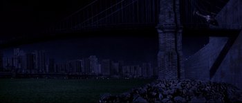 Movie still from “Escape from New York” (1981), directed by John Carpenter – A view of a city at night from under a bridge; Extreme Wide shot, Low angle