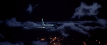 Movie still from “Escape from New York” (1981), directed by John Carpenter – An airplane flying through the night sky; Extreme Wide shot, Overhead angle