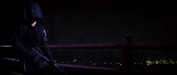 Movie still from “Escape from New York” (1981), directed by John Carpenter – A view of a city at night from a window; Medium shot, Low angle