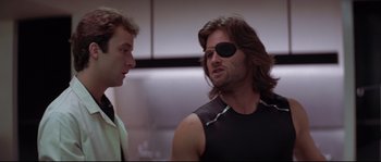 Movie still from “Escape from New York” (1981), directed by John Carpenter – A man with a bandage on his eye and a man with a bandage on his face; Close Up shot, Low angle