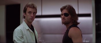 Movie still from “Escape from New York” (1981), directed by John Carpenter – A man with a bandaged eye stands next to another man; Close Up shot, Low angle
